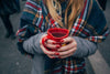 Woman with red nail polish holding a mug