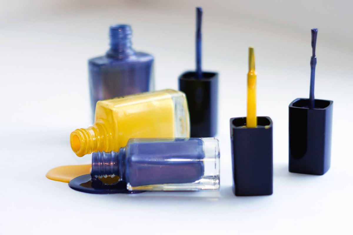 A group of different colored bottles with toothbrushes in them photo
