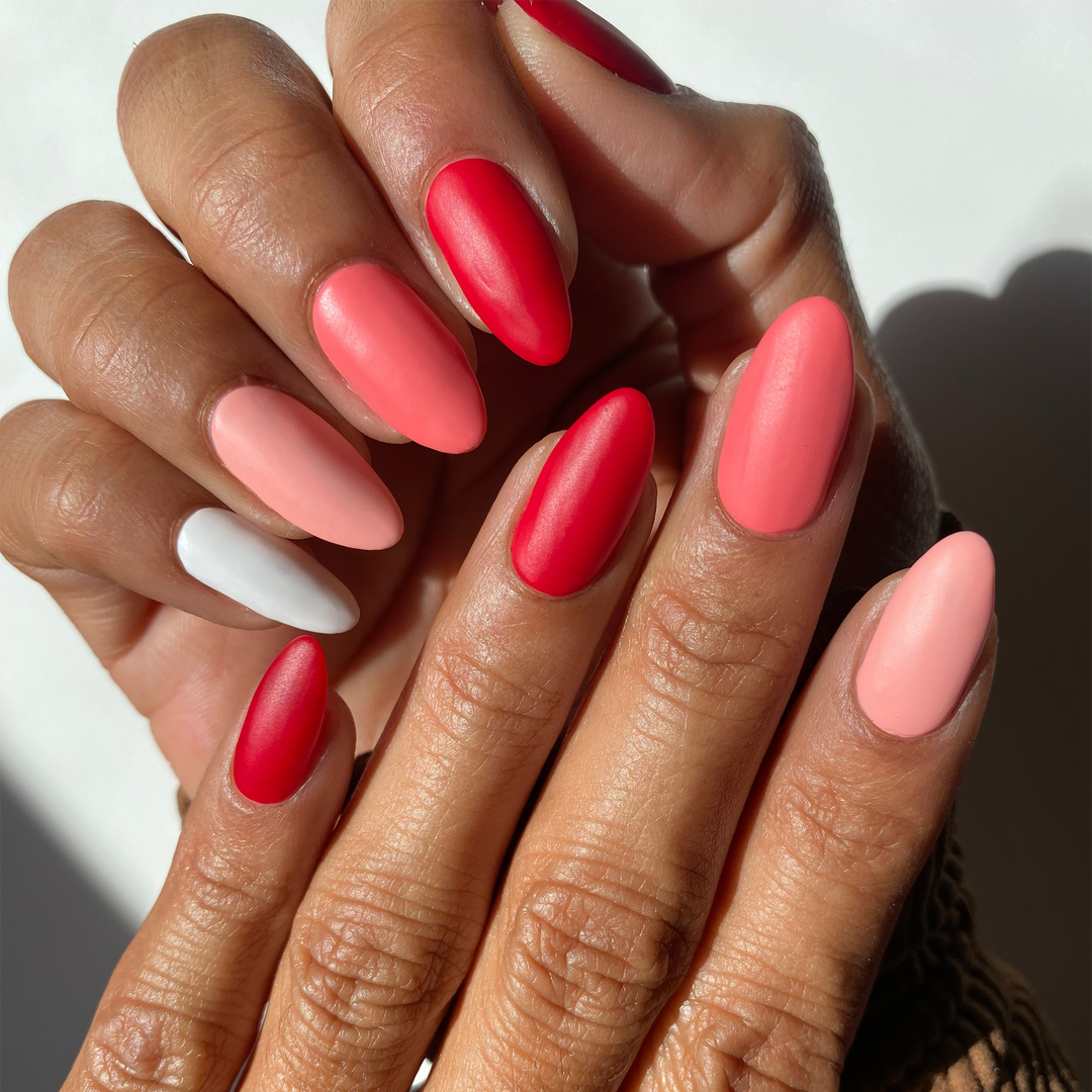 Candy Cane Dreams red, coral pink and white mix-and-match manicure, two hands