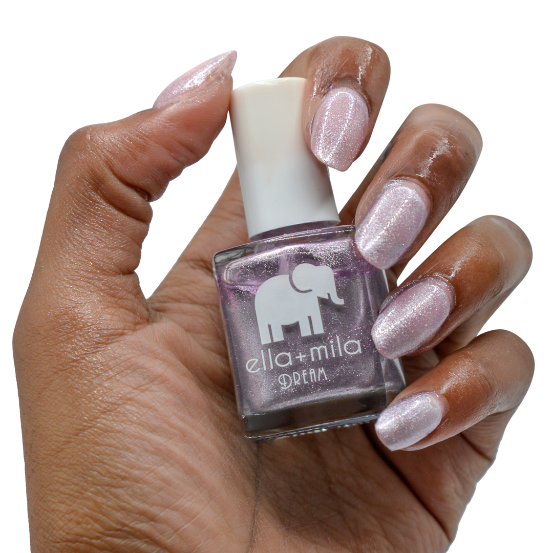 Dolled Up metallic silver purple nail polish on a deep skin tone, hand holding the bottle