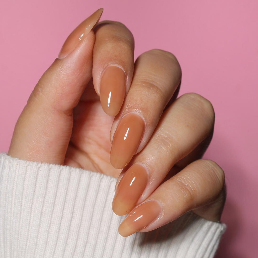 Golden Crown milky brown nail polish manicure on a medium skin tone with a white sweater