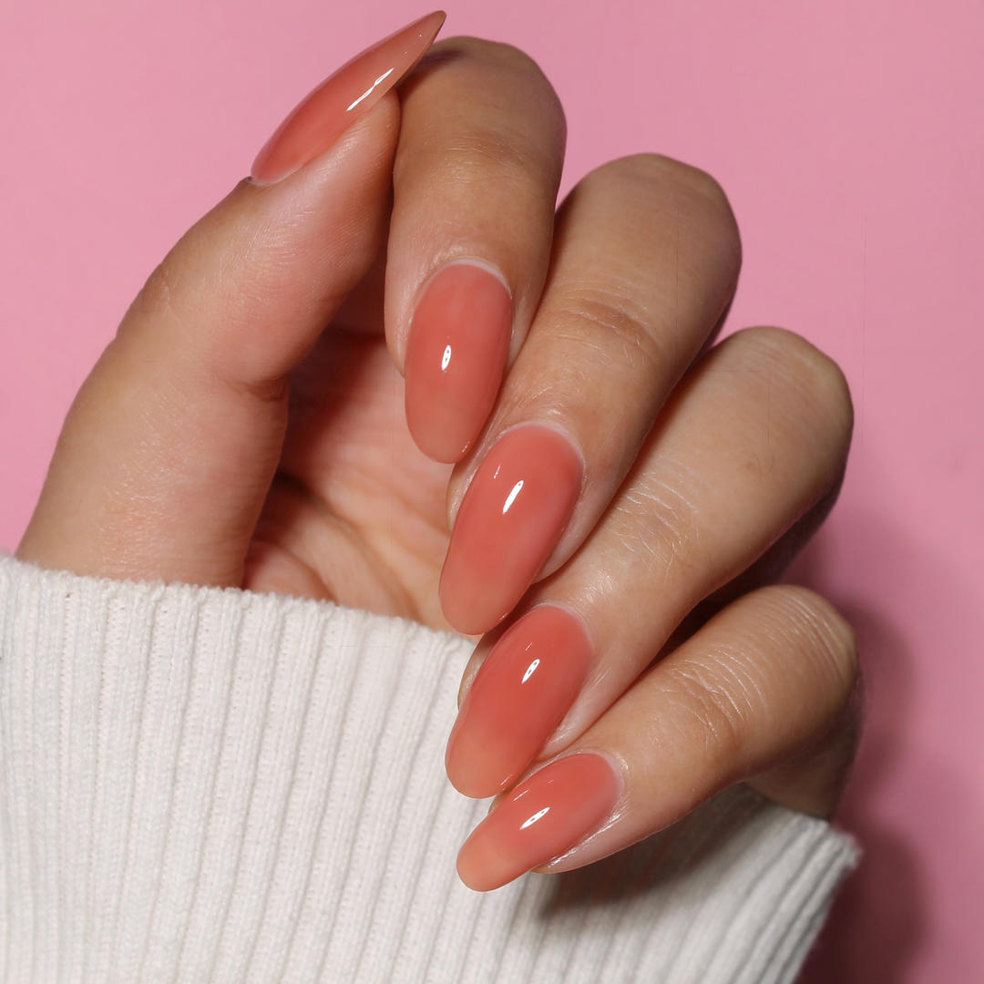 My Legacy milky dusty rose nail polish manicure on a light skin tone with a white sweater