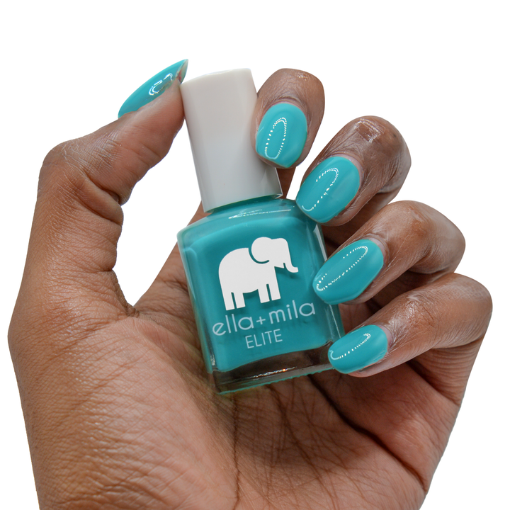 One Way Ticket teal nail polish on a deep skin tone, hand holding the bottle