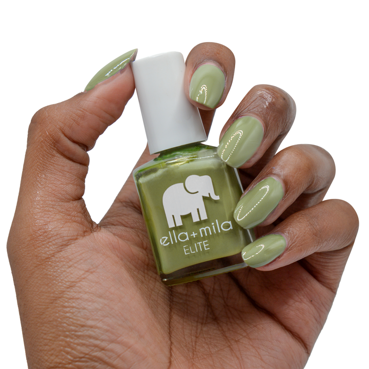 Paradise Isle army green nail polish on a deep skin tone, hand holding the bottle