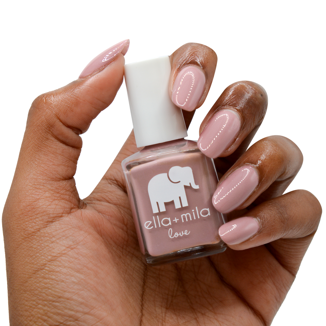 Sugar Fairy rosy nude nail polish on a deep skin tone, hand holding the bottle