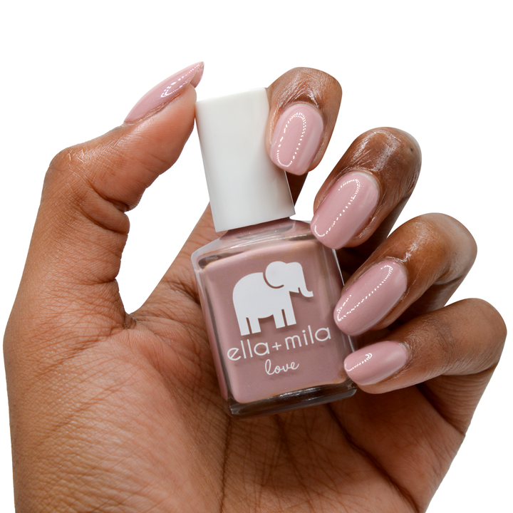 Sugar Fairy rosy nude nail polish on a deep skin tone, hand holding the bottle