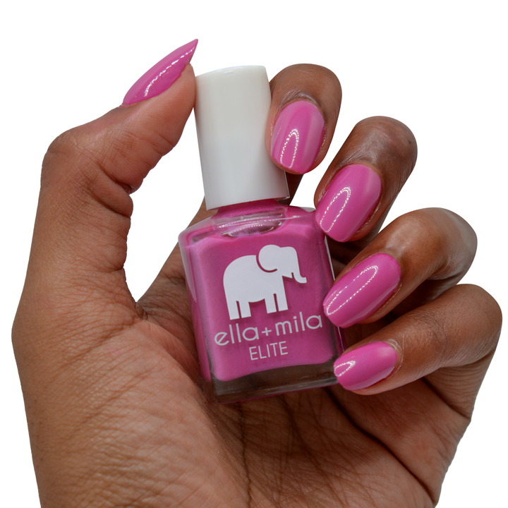 Summer Roam-ance berry pink nail polish on a deep skin tone, hand holding the bottle