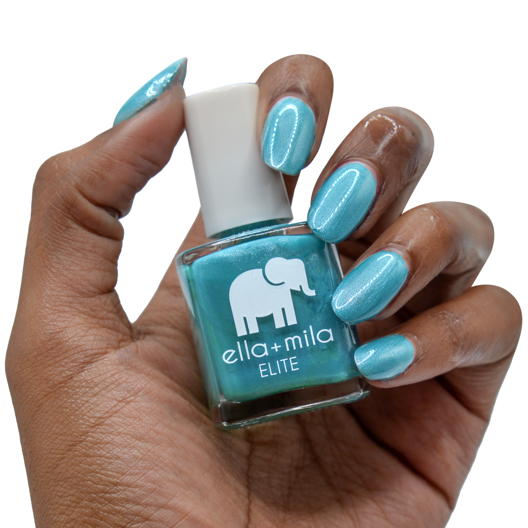 Under the Sea shimmery teal nail polish on a deep skin tone, hand holding the bottle