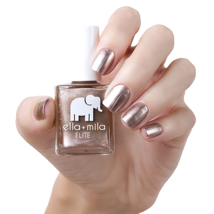 Champagne Pop metallic rose gold nail polish manicure on a light skin tone with the bottle