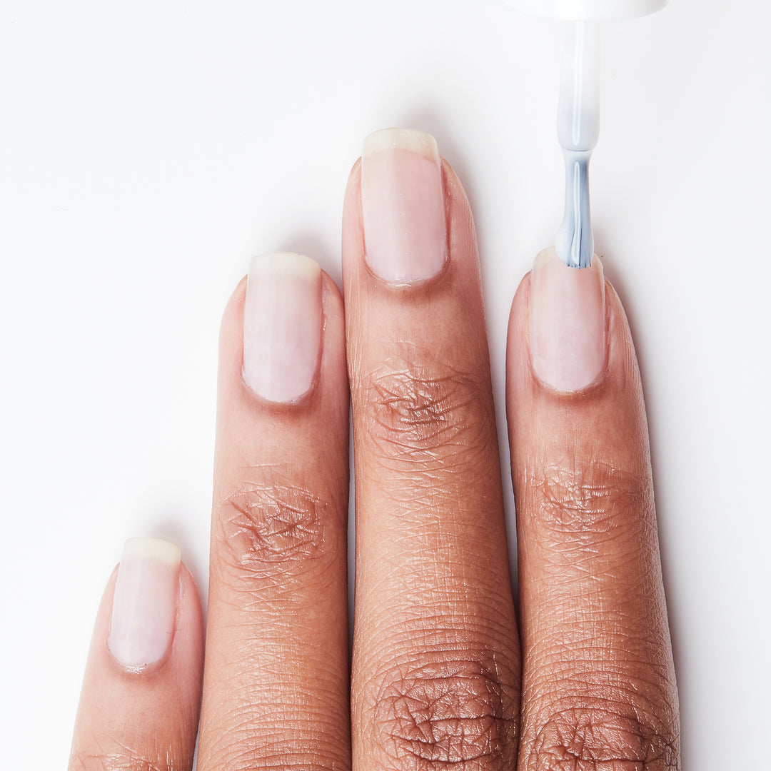 Applying Cover Your Bases ridge-filler base coat on bare nails
