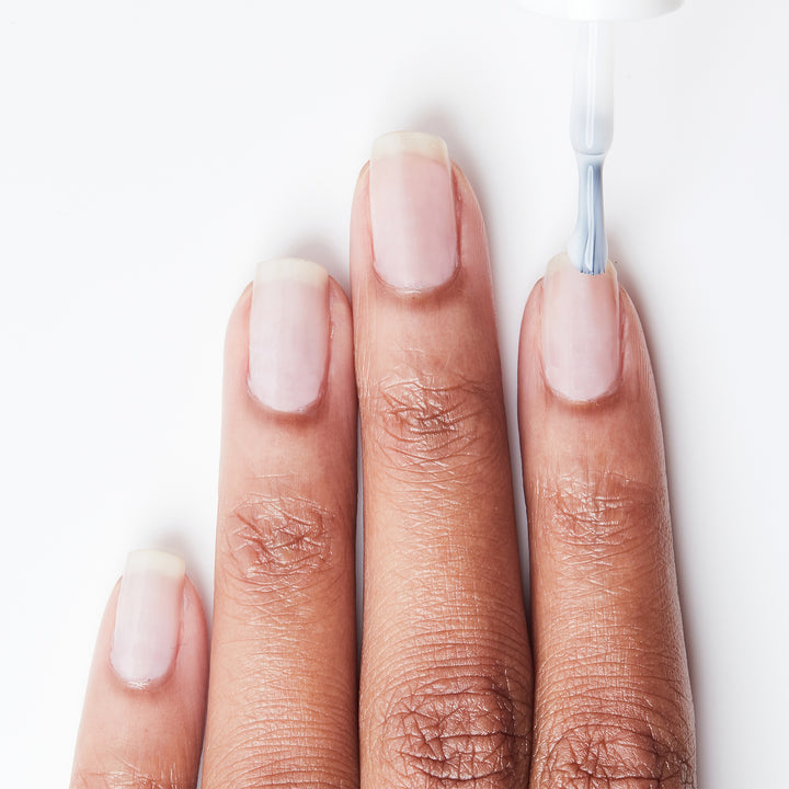 Applying Cover Your Bases ridge-filler base coat on bare nails
