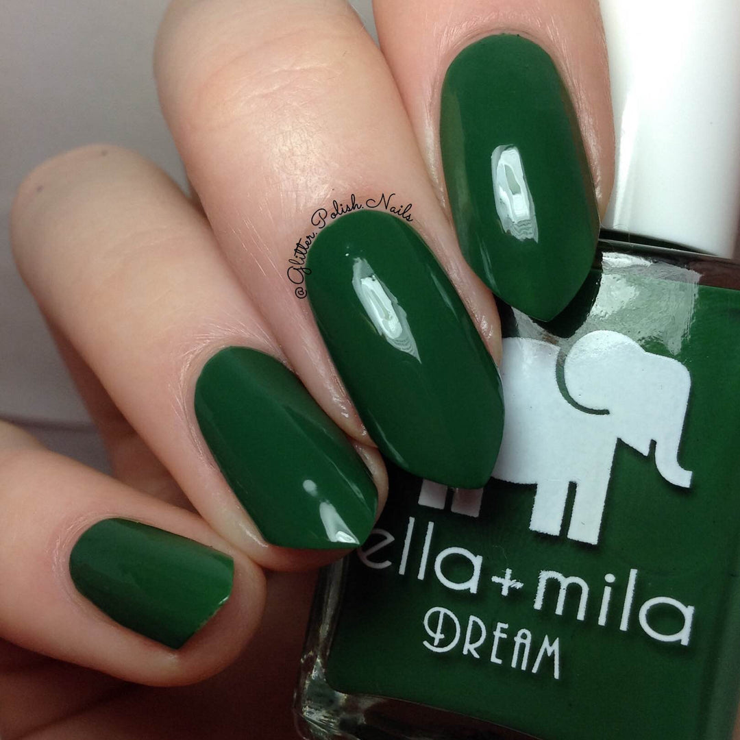 Mistletoe Magic dark holiday green nail polish close-up with the bottle
