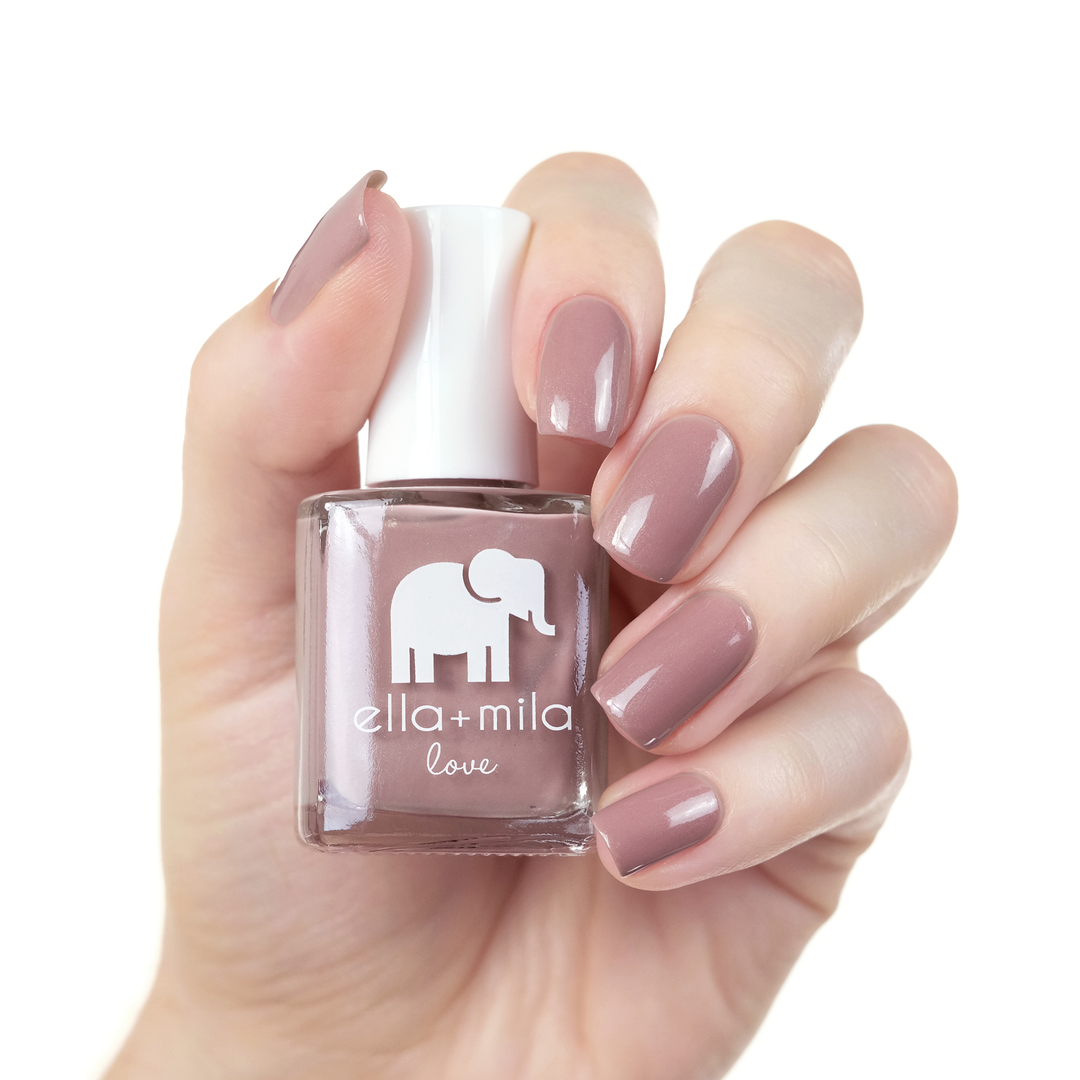 Sugar Fairy rosy nude nail polish manicure on a light skin tone with the bottle