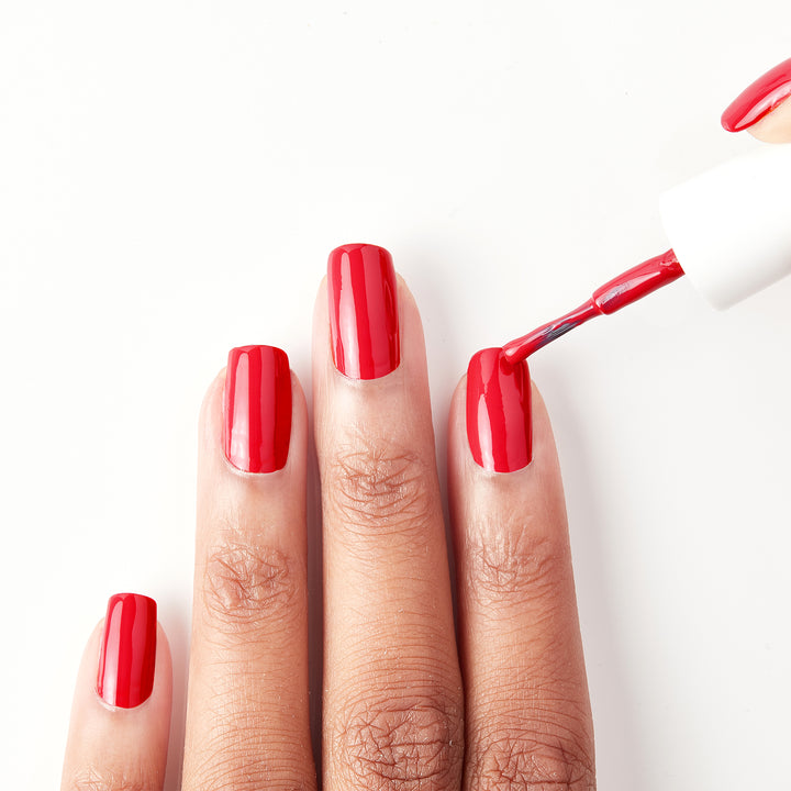 Applying Unwrap Me festive red nail polish
