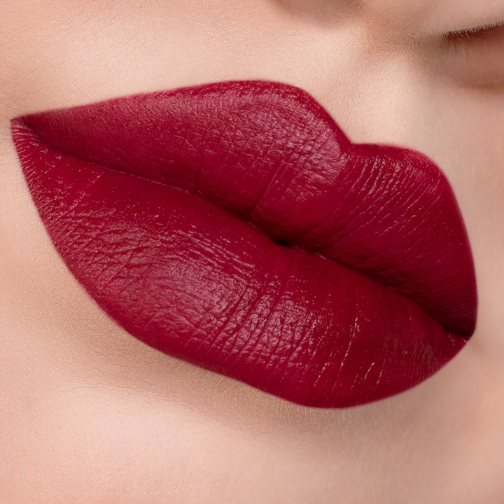 After 5 deep cherry red lipstick on lips, light skin tone close-up