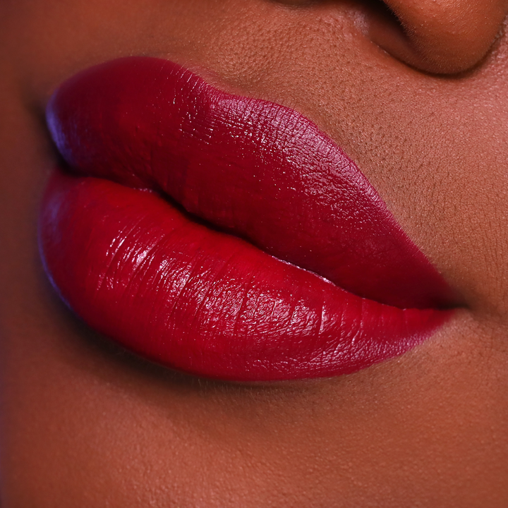 After 5 deep red lipstick on lips, deep skin tone close-up