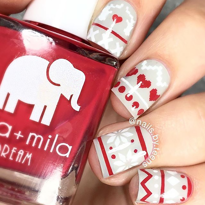 Bad Obsession red nail polish with festive gift and heart nail art