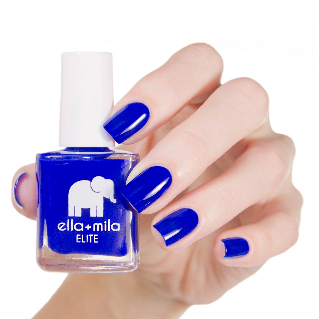 Bags Are Packed royal blue nail polish manicure on a light skin tone with the bottle