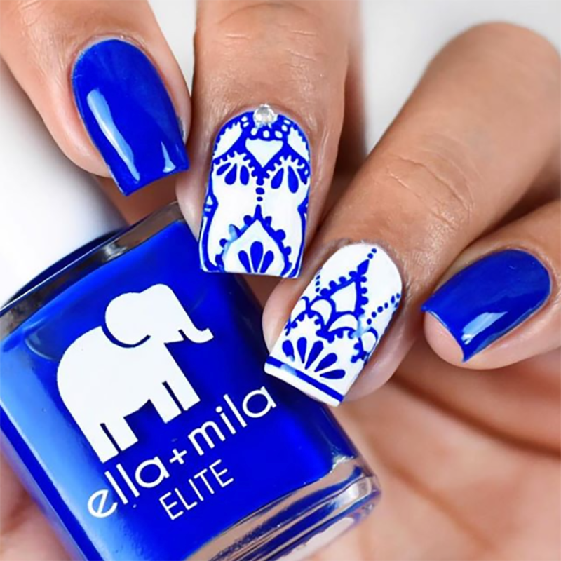 Bags Are Packed royal blue nail polish with white damask nail art