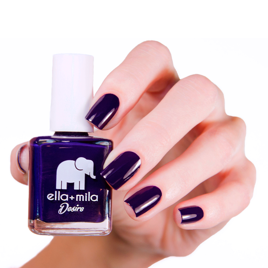 Bite Me vampy purple nail polish manicure on a light skin tone with the bottle