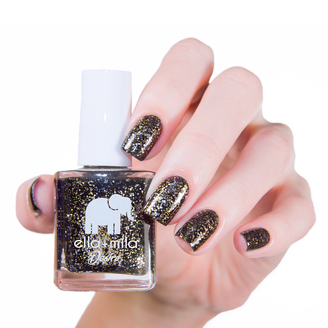 Black Tie Affair black glitter nail polish manicure on a light skin tone with the bottle