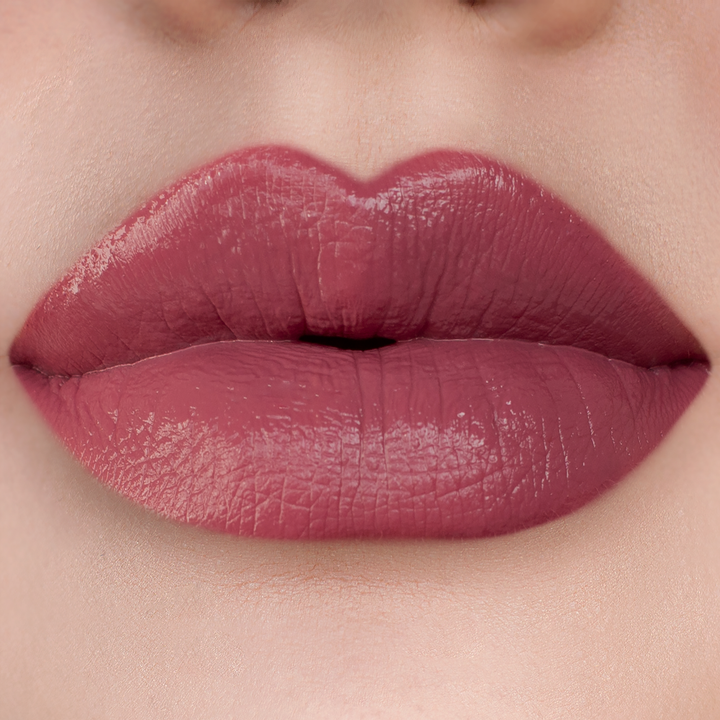 Blush rosy mauve lipstick on lips, light skin tone