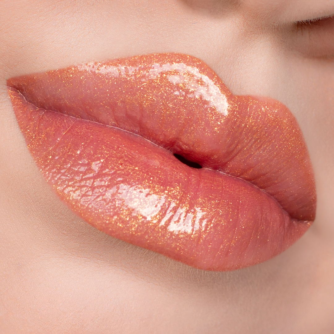 Bronze Babe golden shimmer lip gloss on lips, light skin tone close-up