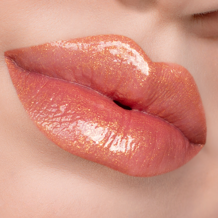 Bronze Babe golden shimmer lip gloss on lips, light skin tone close-up