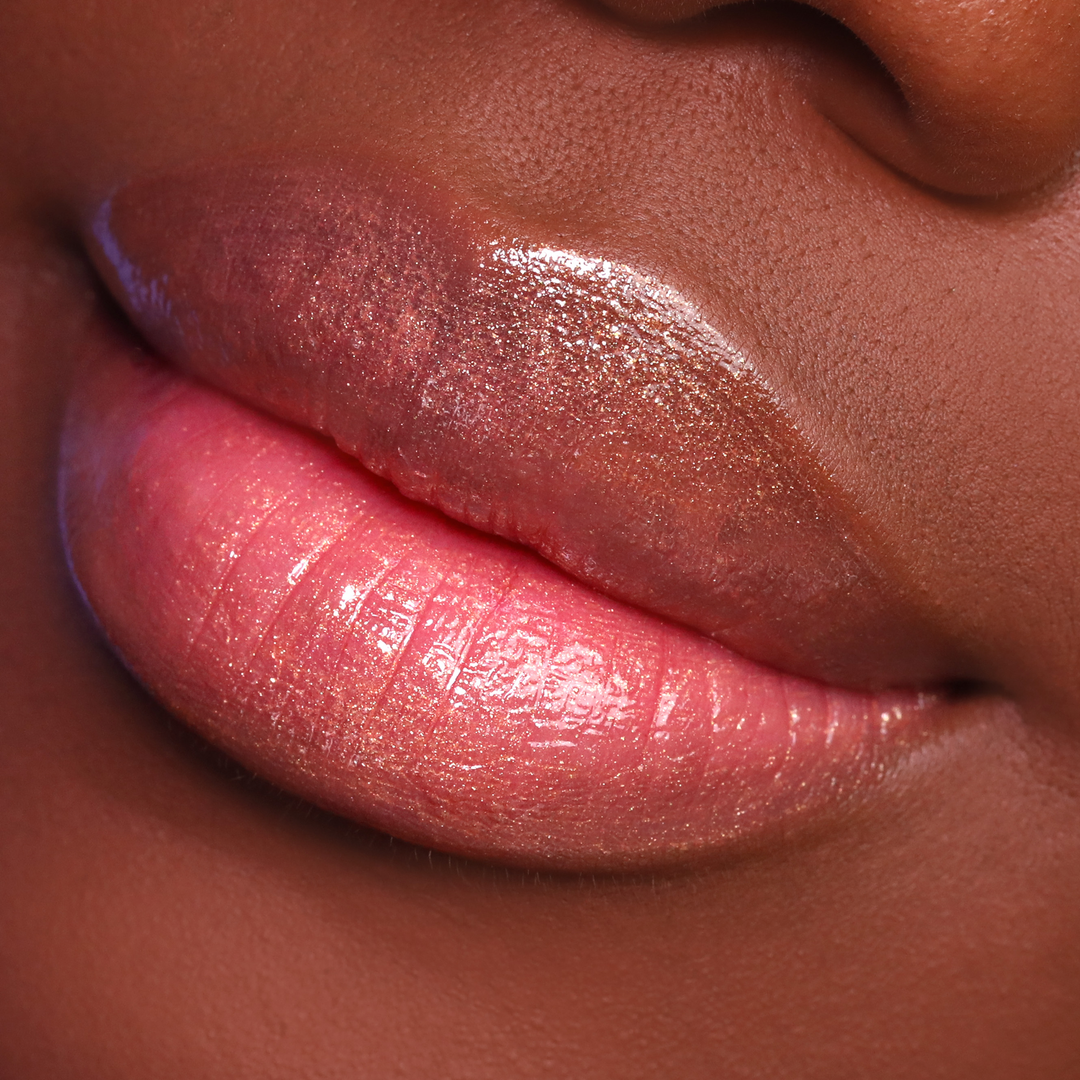 Bronze Babe bronze shimmer lip gloss on lips, deep skin tone close-up