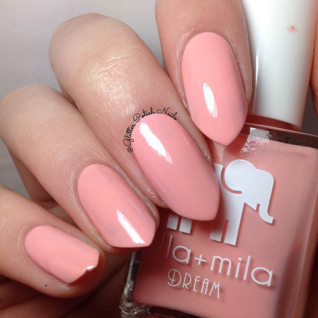 Bubble Trouble peachy bubblegum pink nail polish close-up with the bottle