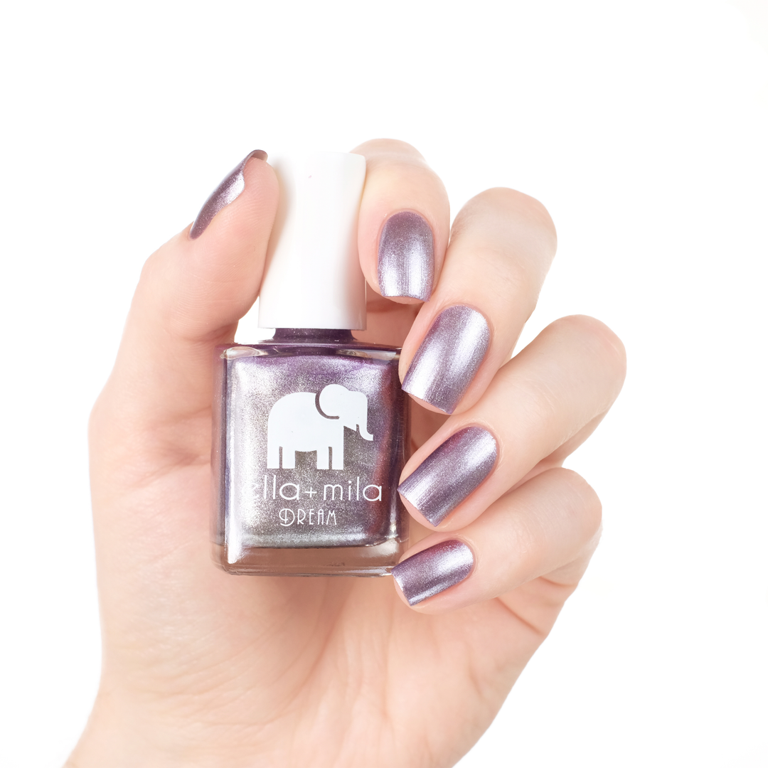 Dolled Up metallic silver purple nail polish manicure on a light skin tone with the bottle