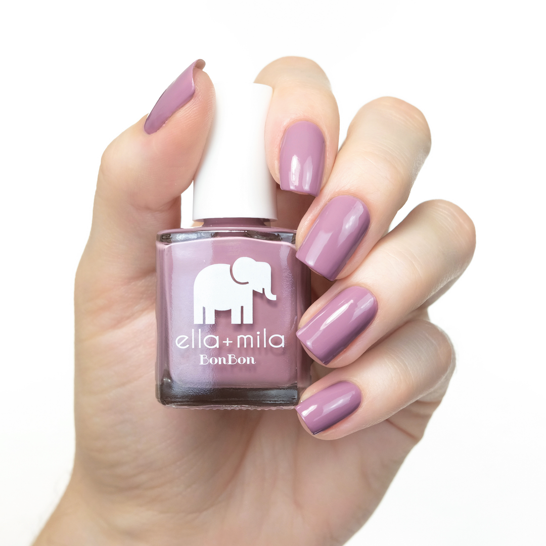 Dulce Amor dusty rose nail polish manicure on a light skin tone with the bottle