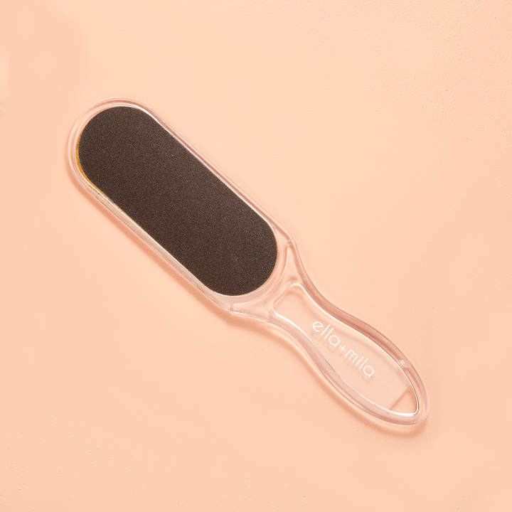 Dual-sided foot file on a peach background