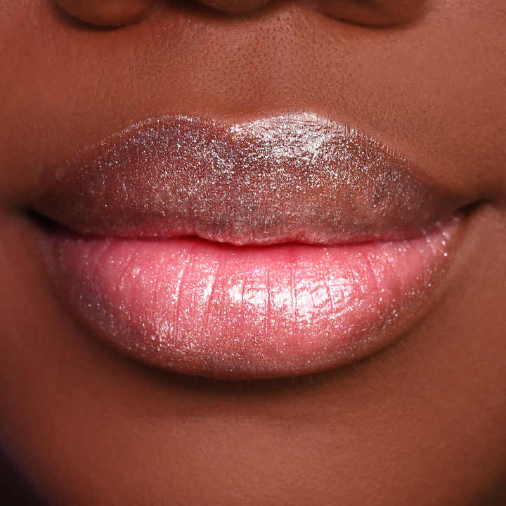 Get the Glow shimmer lip gloss on lips, medium-deep skin tone