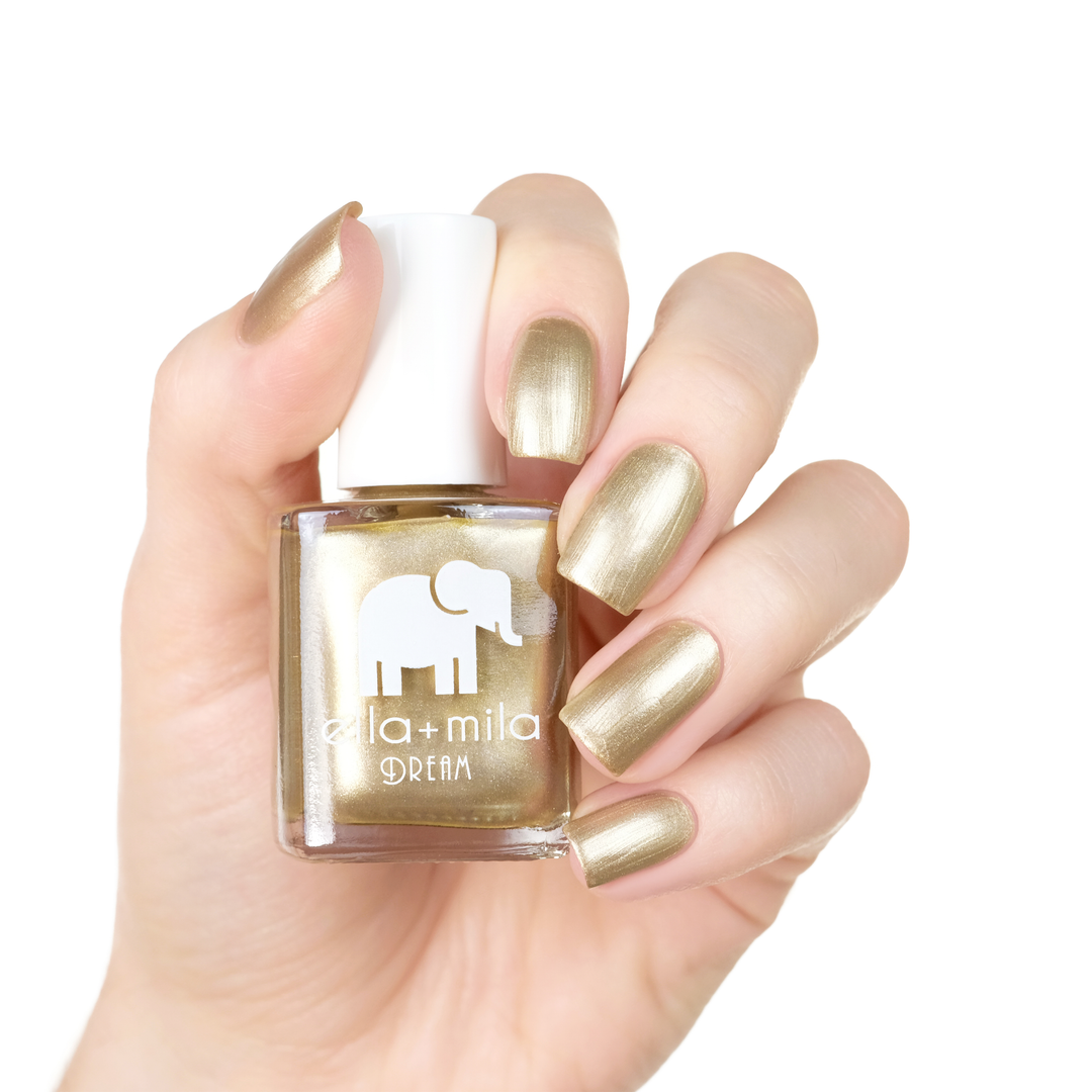 Gilded metallic gold nail polish manicure on a light skin tone with the bottle