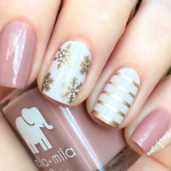 Gilded gold nail polish accents with mauve and white winter nail art
