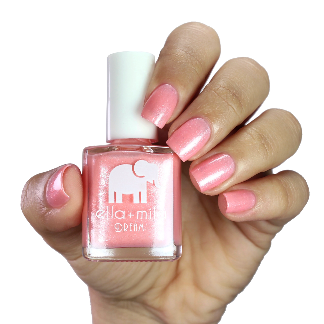 Glisten to Me pale pink shimmer nail polish manicure on a light skin tone with the bottle