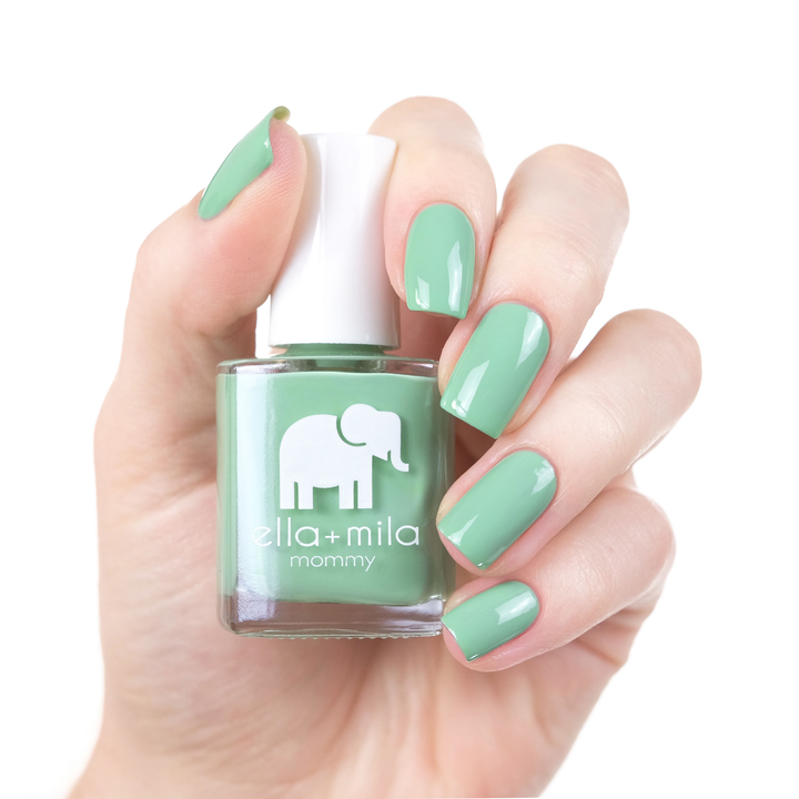 I Mint It mint green nail polish manicure on a light skin tone with the bottle