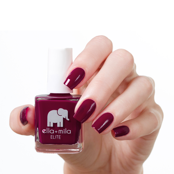 In Line for Wine wine red nail polish manicure on a light skin tone with the bottle