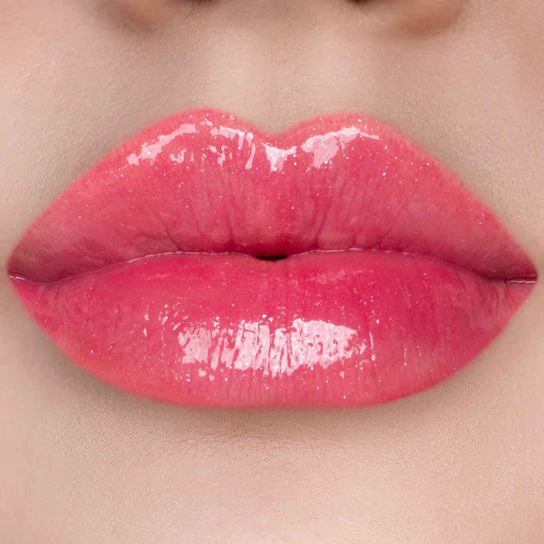 Just Cheeky berry pink lip gloss on lips, light skin tone