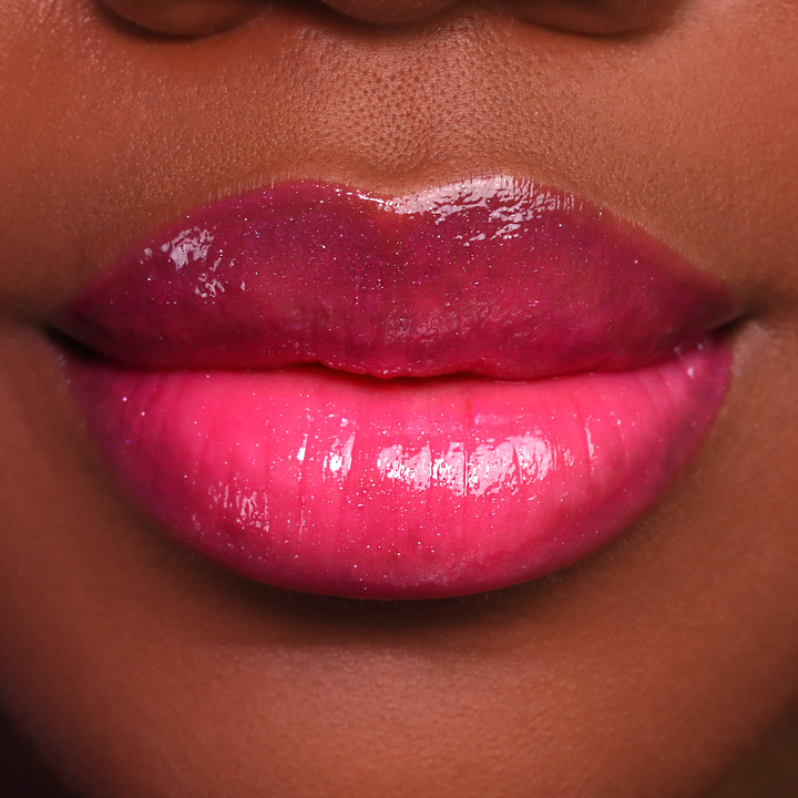 Just Cheeky berry pink lip gloss on lips, deep skin tone