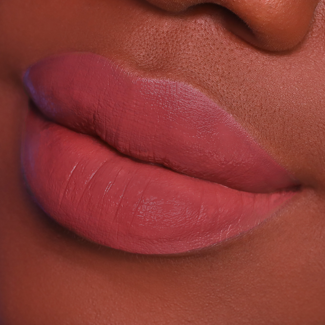 Just Right rosewood lipstick on lips, deep skin tone close-up