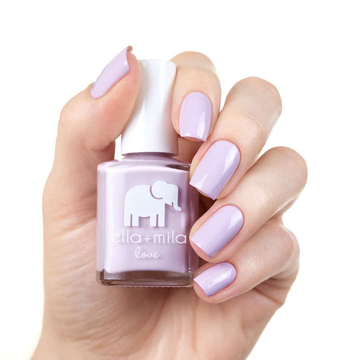 Lilac Luster pastel lilac nail polish manicure on a light skin tone with the bottle
