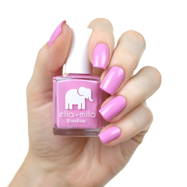 Macaruin My Diet pastel purple pink nail polish on a medium skin tone, hand holding the bottle
