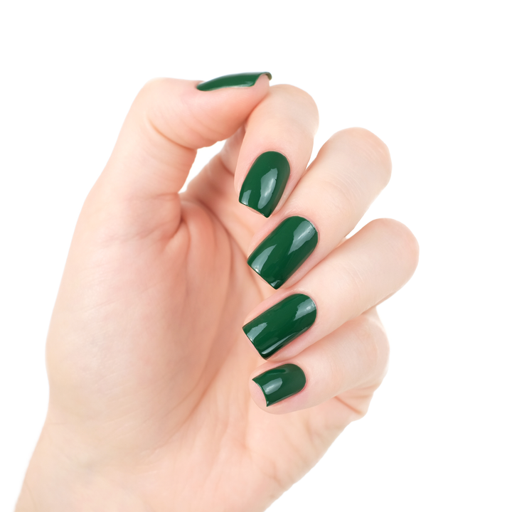 Mistletoe Magic dark holiday green nail polish manicure on a light skin tone