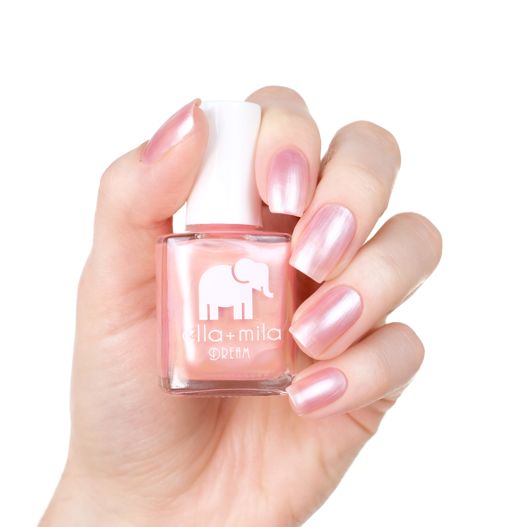 My Fantasy pearly soft pink nail polish manicure on a light skin tone with the bottle