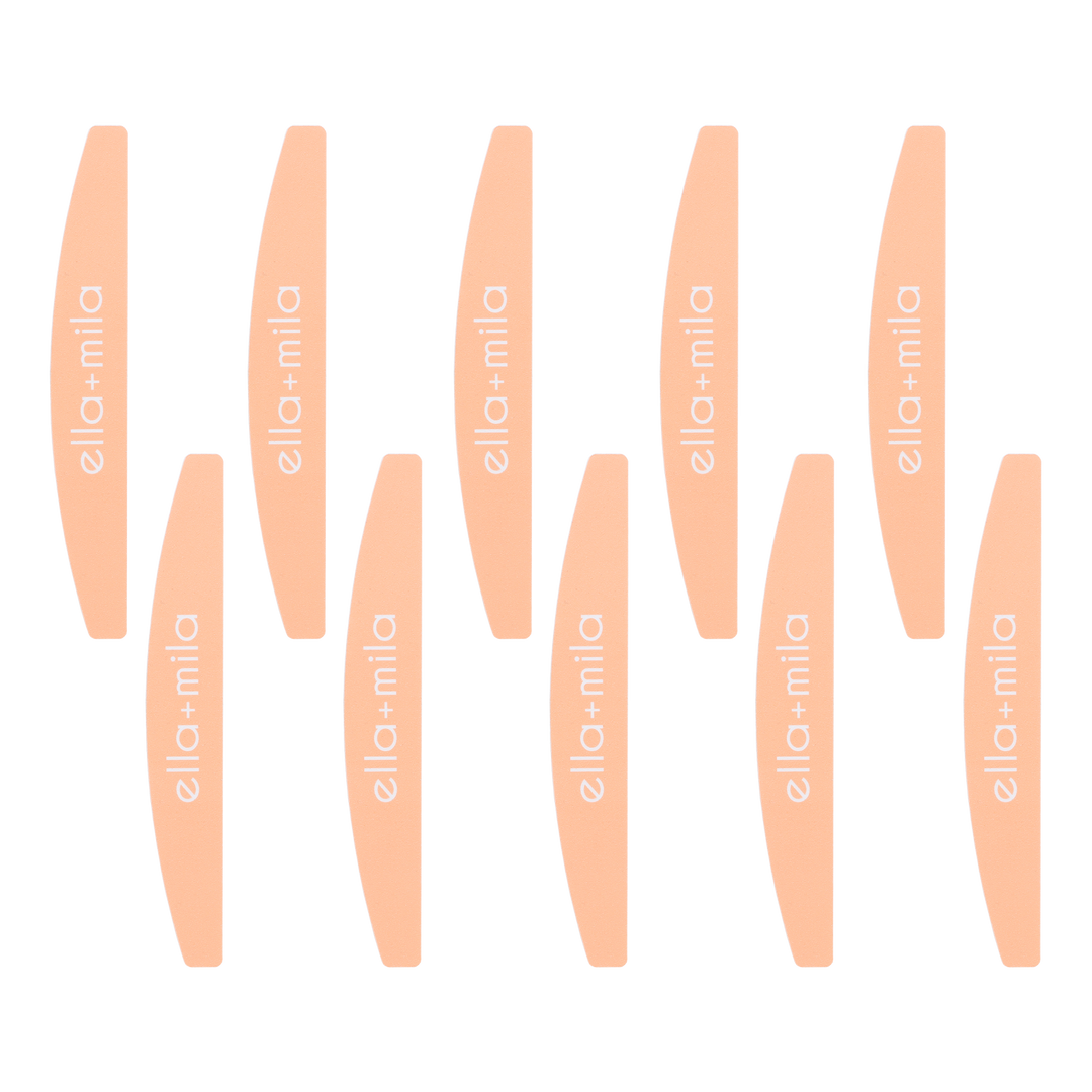 Ten peach half-moon nail files arranged in rows