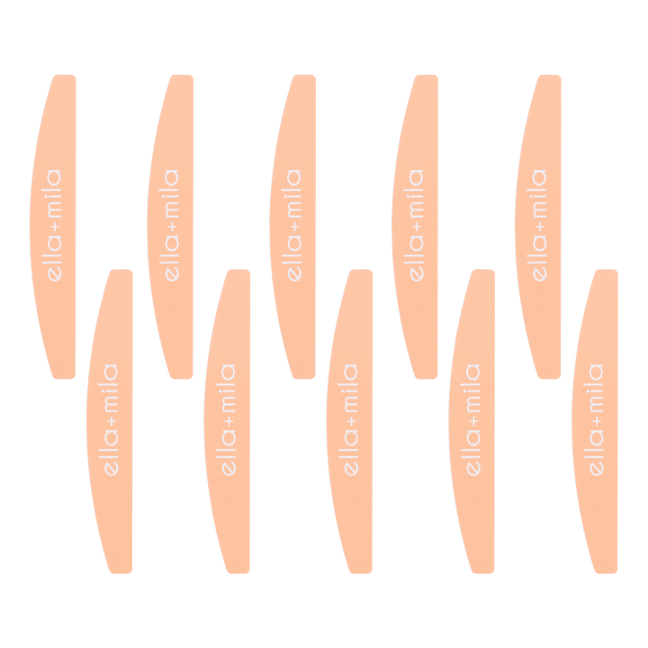 Ten peach half-moon nail files arranged in rows