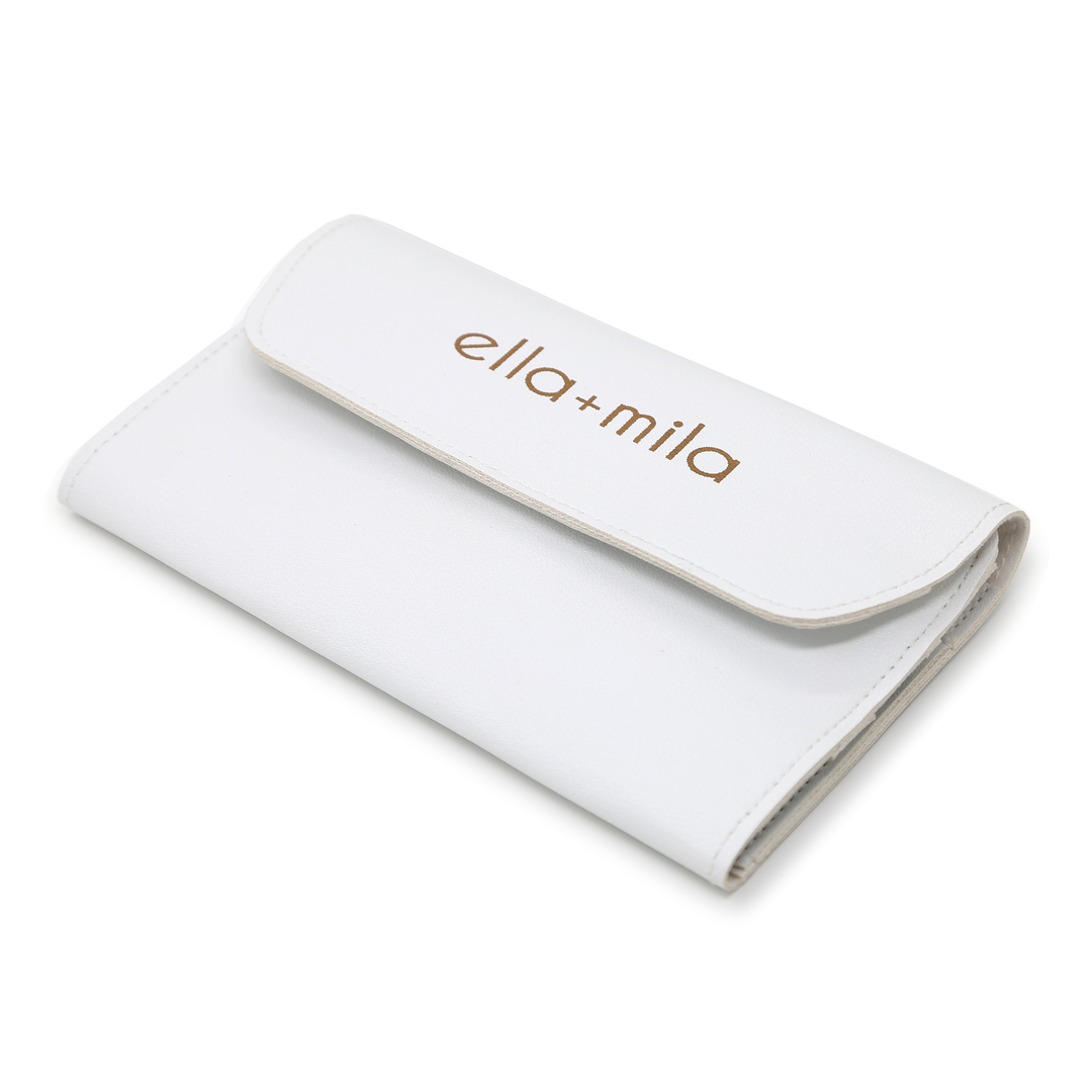 White faux-leather manicure tool case, closed with embossed ella+mila logo