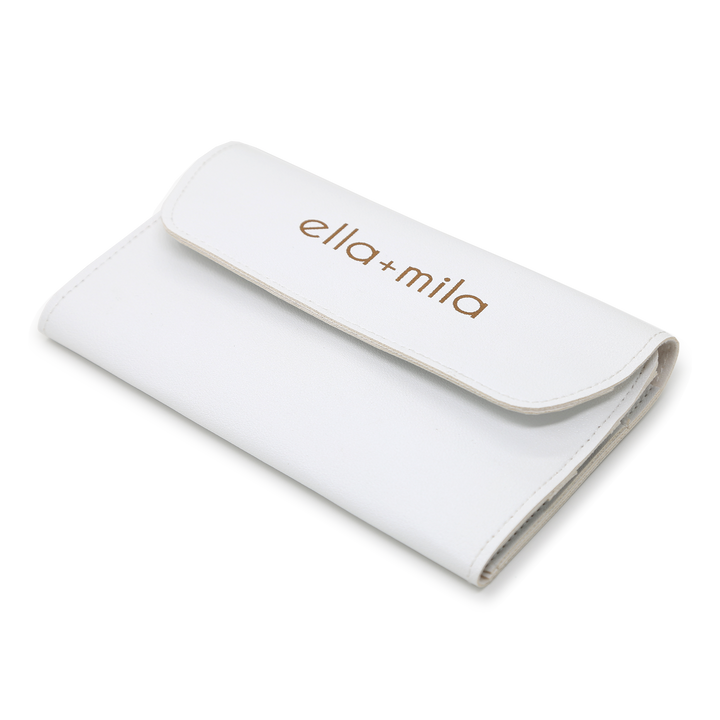 White faux-leather manicure tool case, closed with embossed ella+mila logo